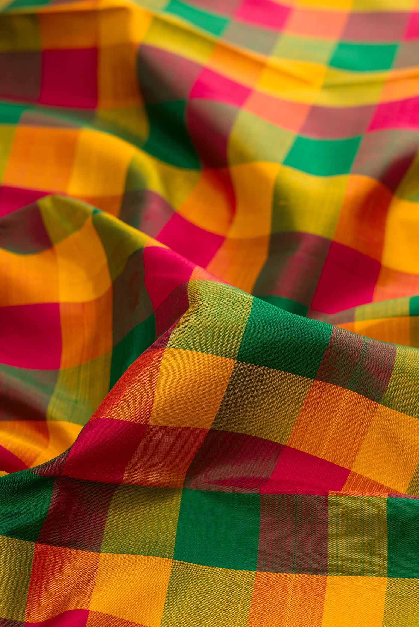 Close up of Multi Color Kanjivaram Silk Saree with Checked design on the body and Without Border.  displaying folds