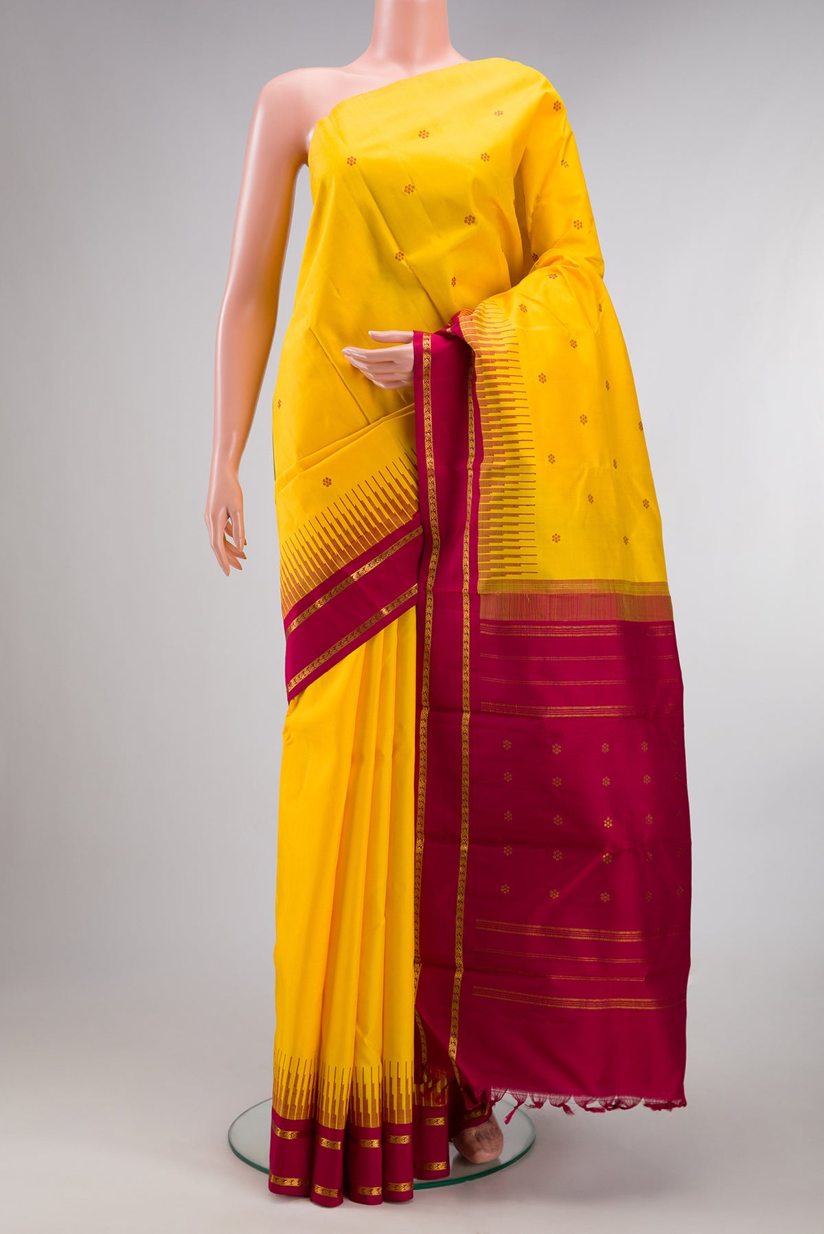 Pure Silk Pure Zari Yellow Kanjivaram Saree with Thread Butta on the body and One Side Border.  displayed on a mannequin
