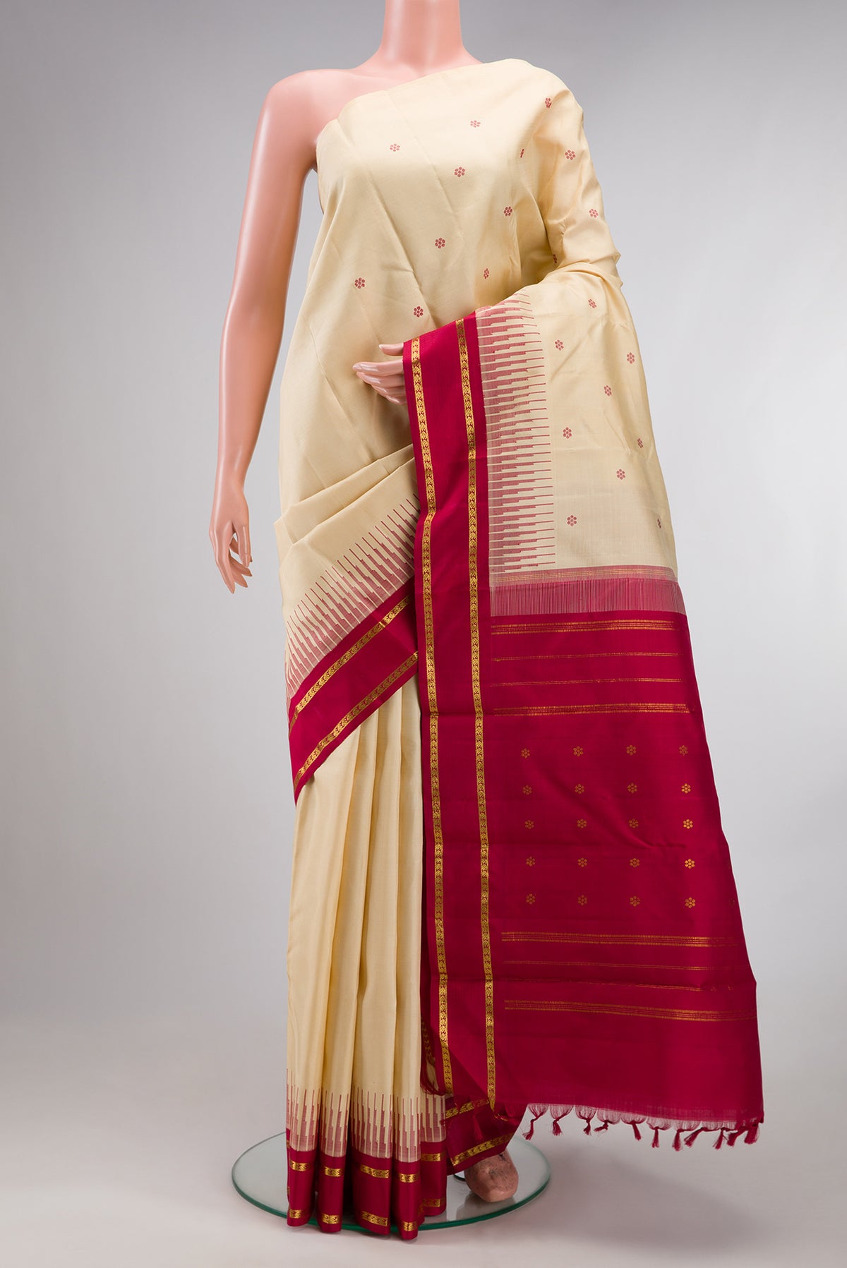 Pure Silk Pure Zari Sandal Kanjivaram Saree with Thread Butta on the body and Plain Border.  displayed on a mannequin