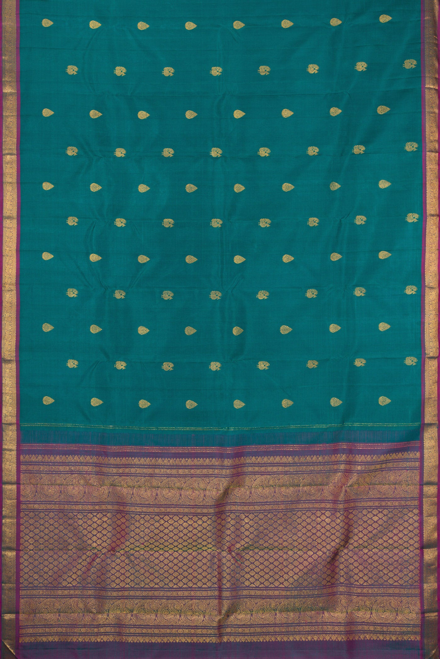 Flat view of Peacock Blue Kanchipuram Silk Saree with Zari Butta on the body and Zari Border. 