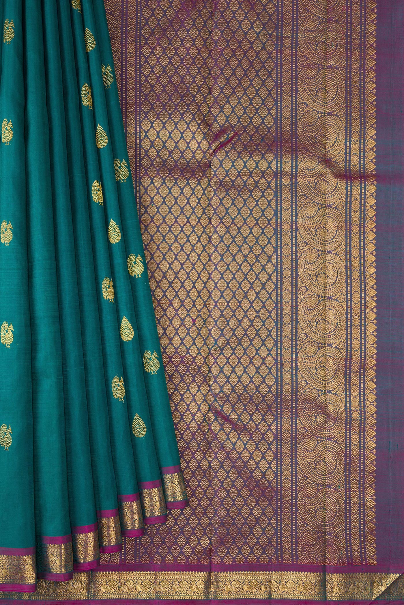 Pleats and pallu of Peacock Blue Kanchipuram Silk Saree with Zari Butta on the body and Zari Border. 