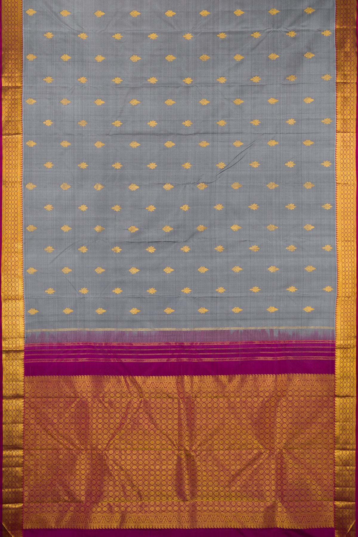 Flat view of Grey Kanchipuram Silk Saree with Zari Butta on the body and Zari Border. 