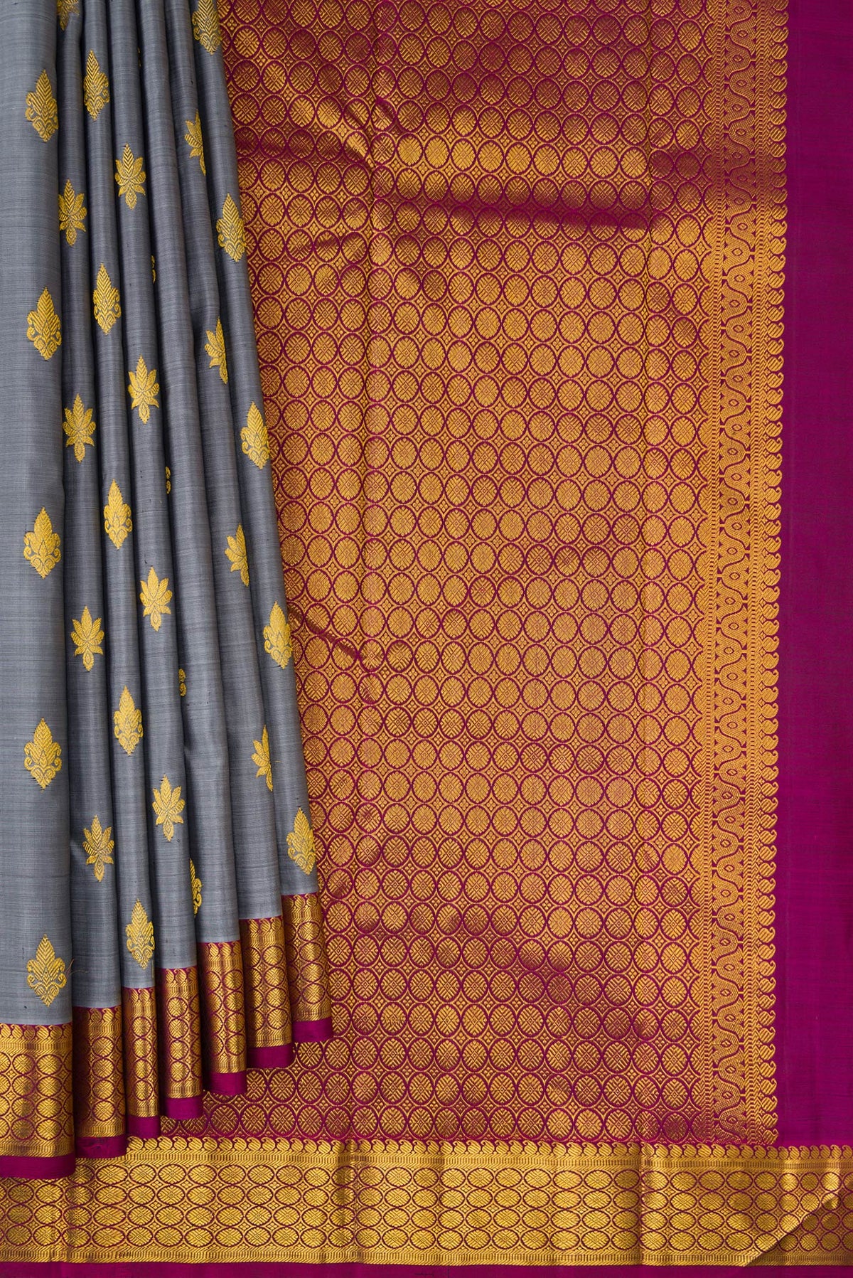 Pleats and pallu of Grey Kanchipuram Silk Saree with Zari Butta on the body and Zari Border. 