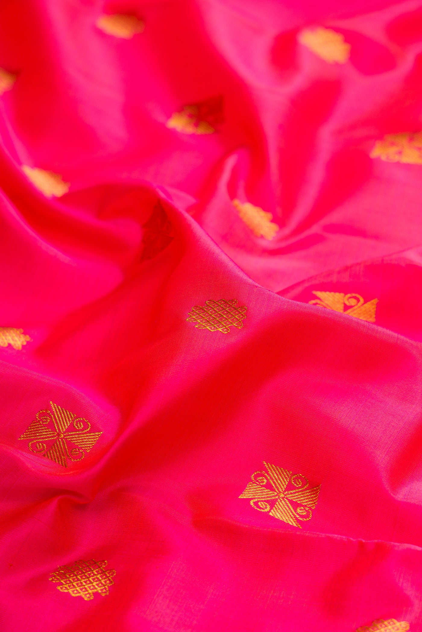 Close up of Pink Dual Tone Kanchipuram Silk Saree with Zari Butta on the body and Zari Border.  displaying folds
