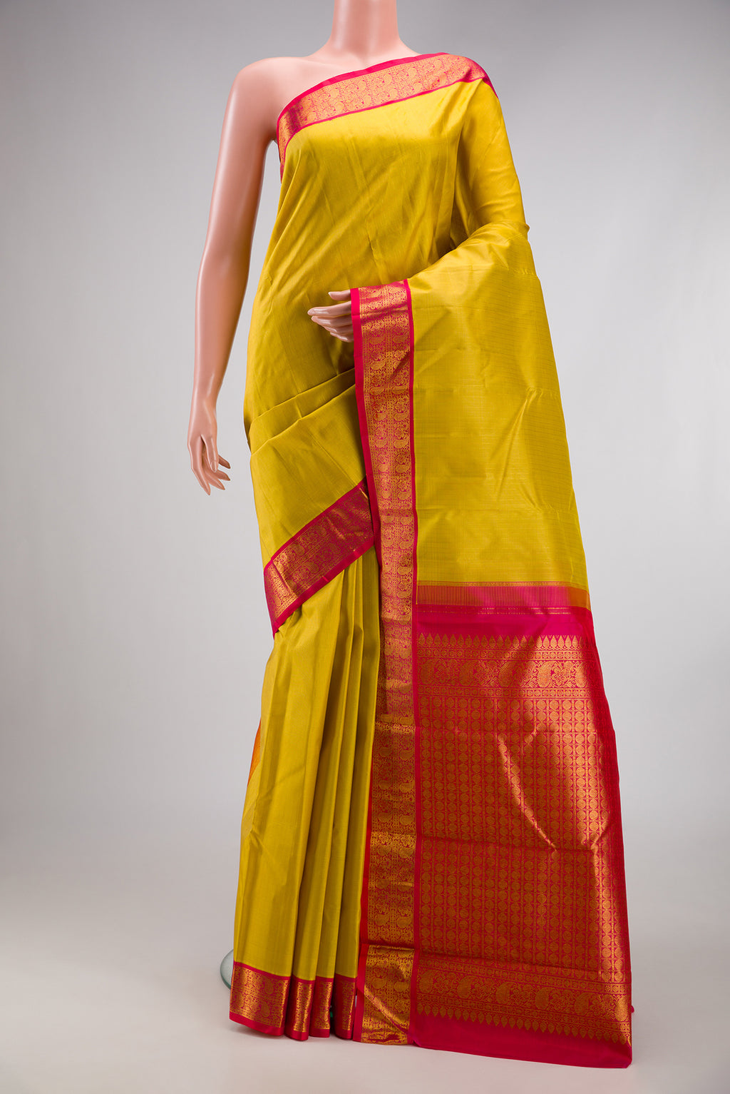 Lemon Yellow Kanjivaram Silk Saree with Stripes on the body and Zari Border.  displayed on a mannequin
