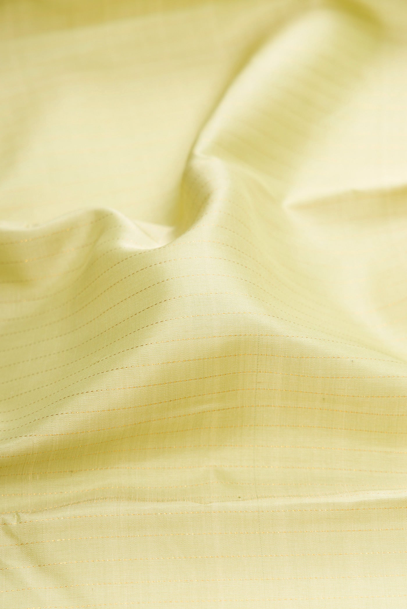 Close up of Pista Green Kanjivaram Silk Saree with Stripes on the body and Zari Border.  displaying folds