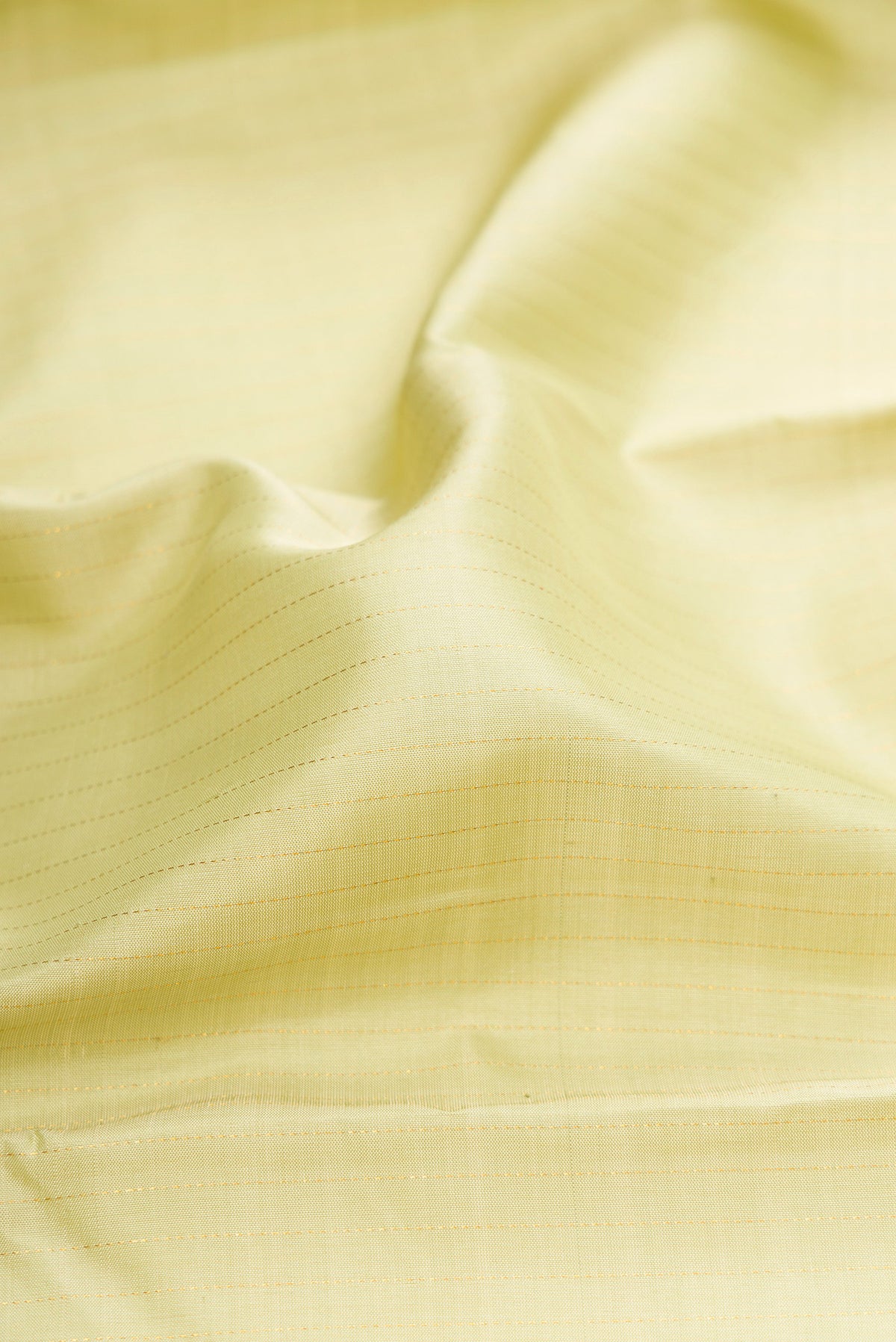 Close up of Pista Green Kanjivaram Silk Saree with Stripes on the body and Zari Border.  displaying folds