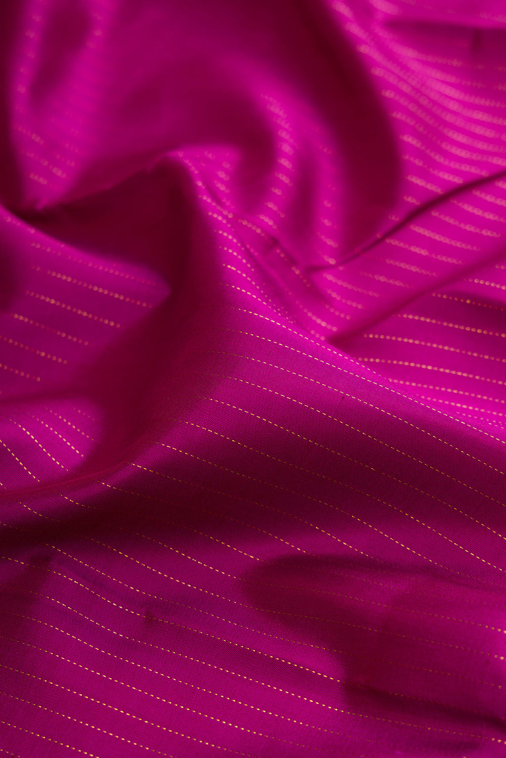 Close up of Purple Kanjivaram Silk Saree with Stripes on the body and Zari Border.  displaying folds
