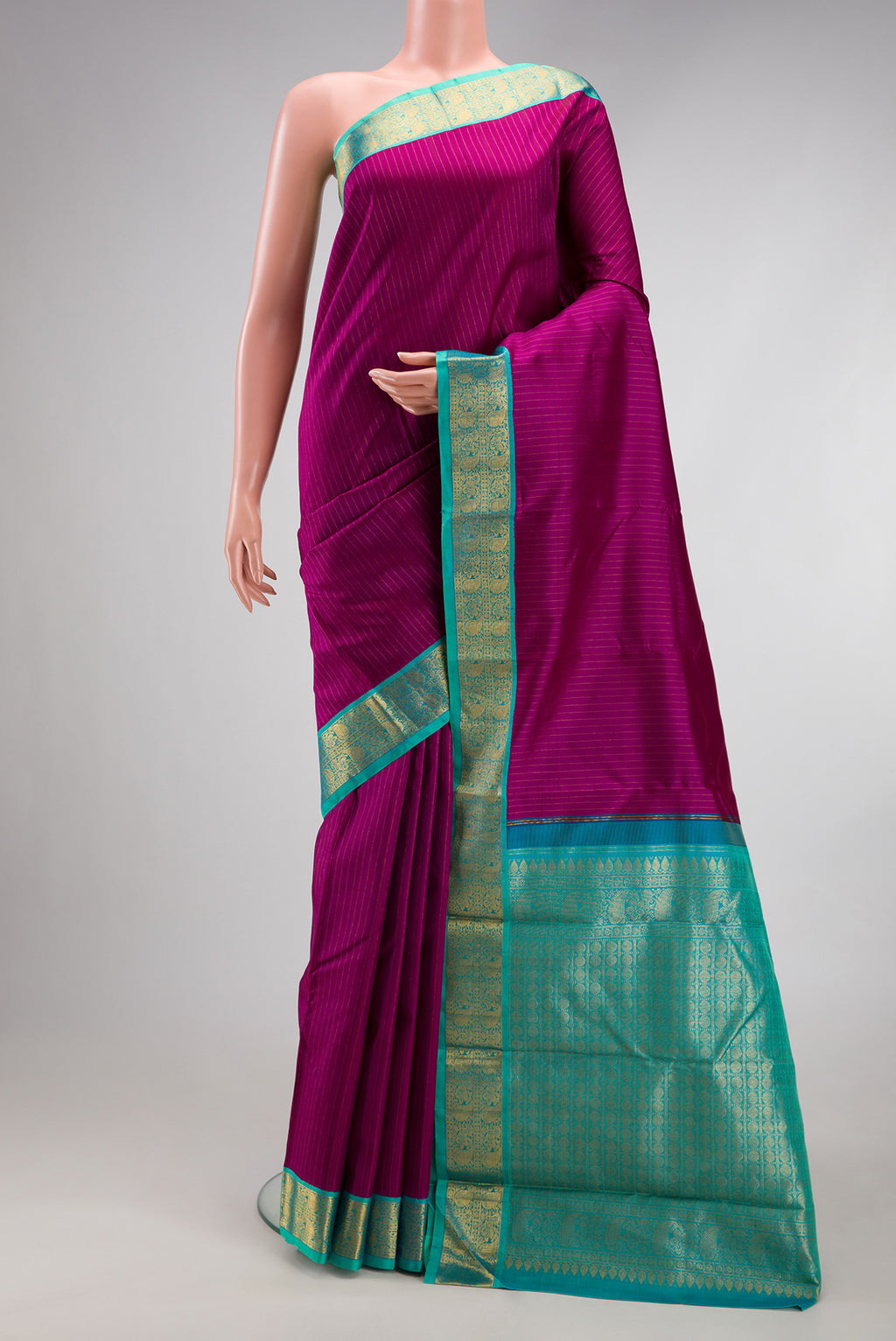 Purple Kanjivaram Silk Saree with Stripes on the body and Zari Border.  displayed on a mannequin