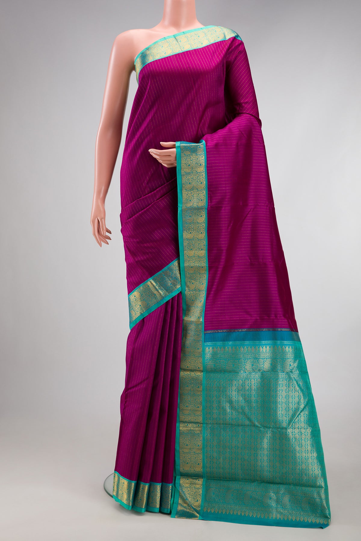 Purple Kanjivaram Silk Saree with Stripes on the body and Zari Border.  displayed on a mannequin