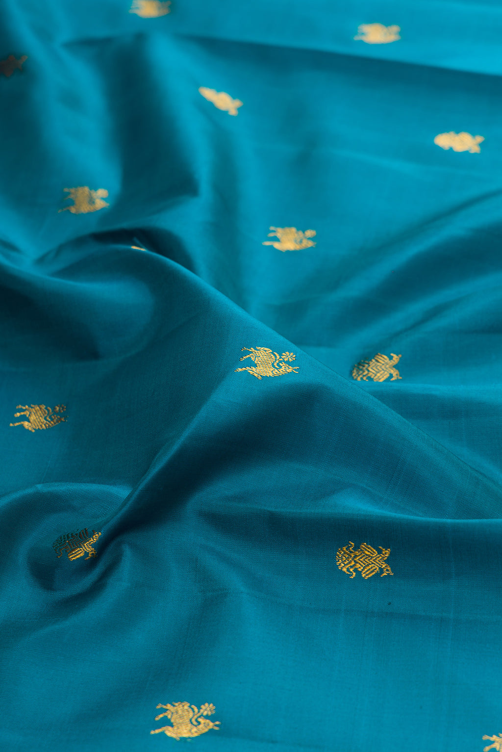 Close up of Blue Kanjivaram Silk Saree with Zari Butta on the body and Zari Border.  displaying folds