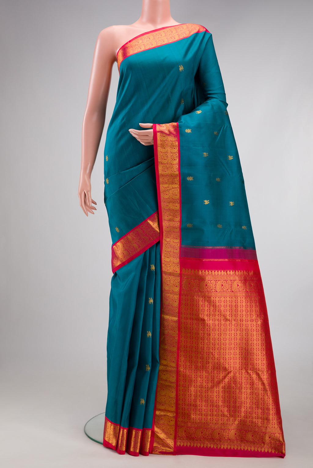 Blue Kanjivaram Silk Saree with Zari Butta on the body and Zari Border.  displayed on a mannequin