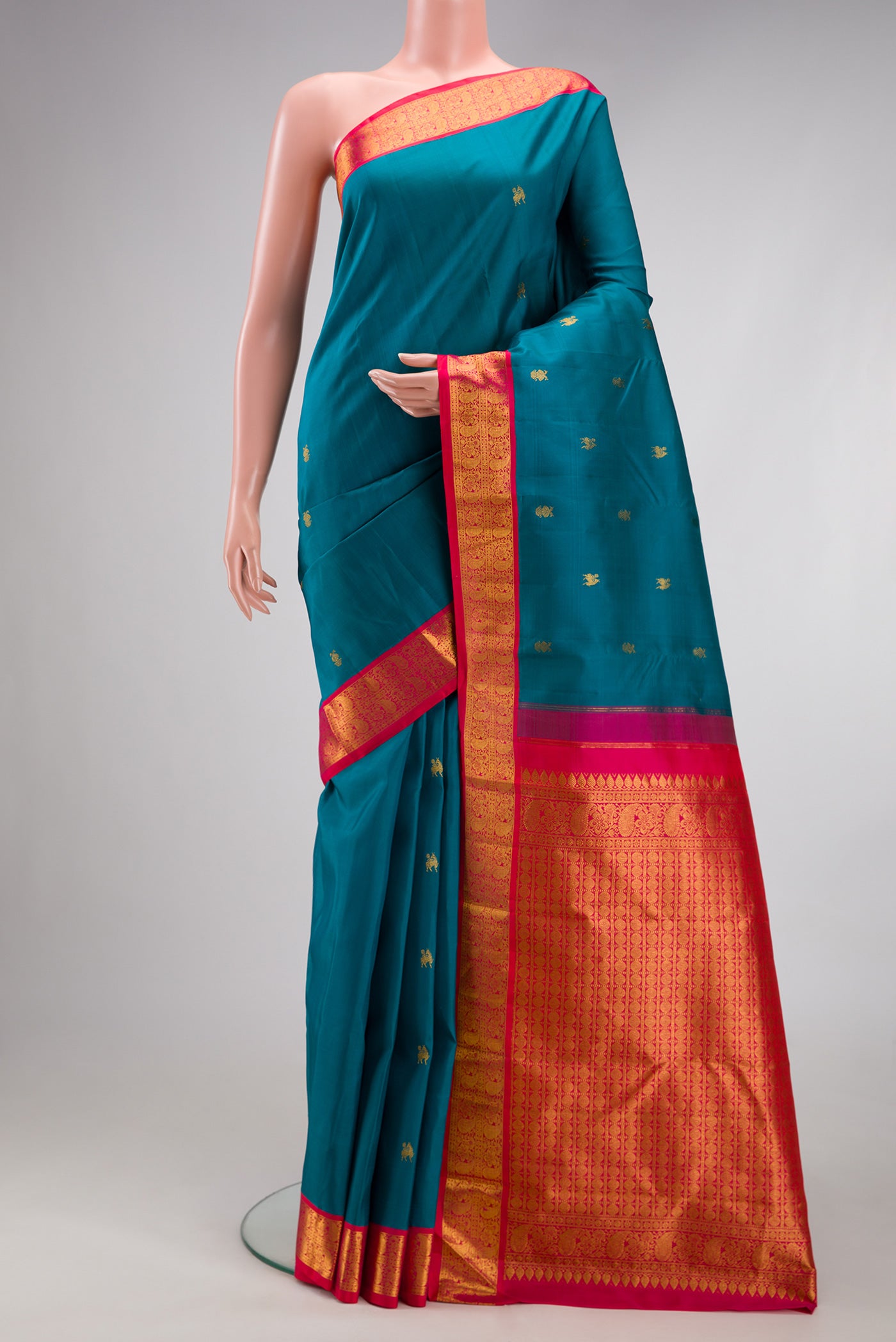 Blue Kanjivaram Silk Saree with Zari Butta on the body and Zari Border.  displayed on a mannequin