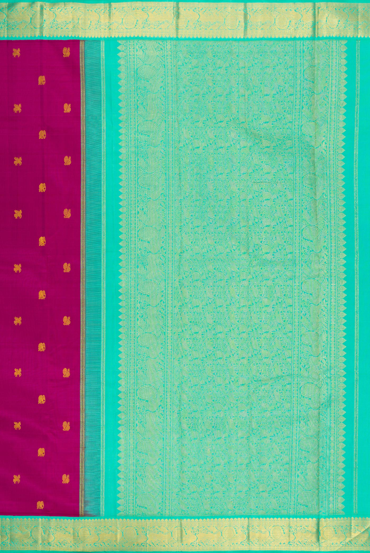Close up image of the pallu of Magenta Kanjivaram Silk Saree with Zari Butta on the body and Zari Border. 