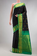 Black Kanjivaram Silk Saree with Zari Butta on the body and Fancy Border.  displayed on a mannequin