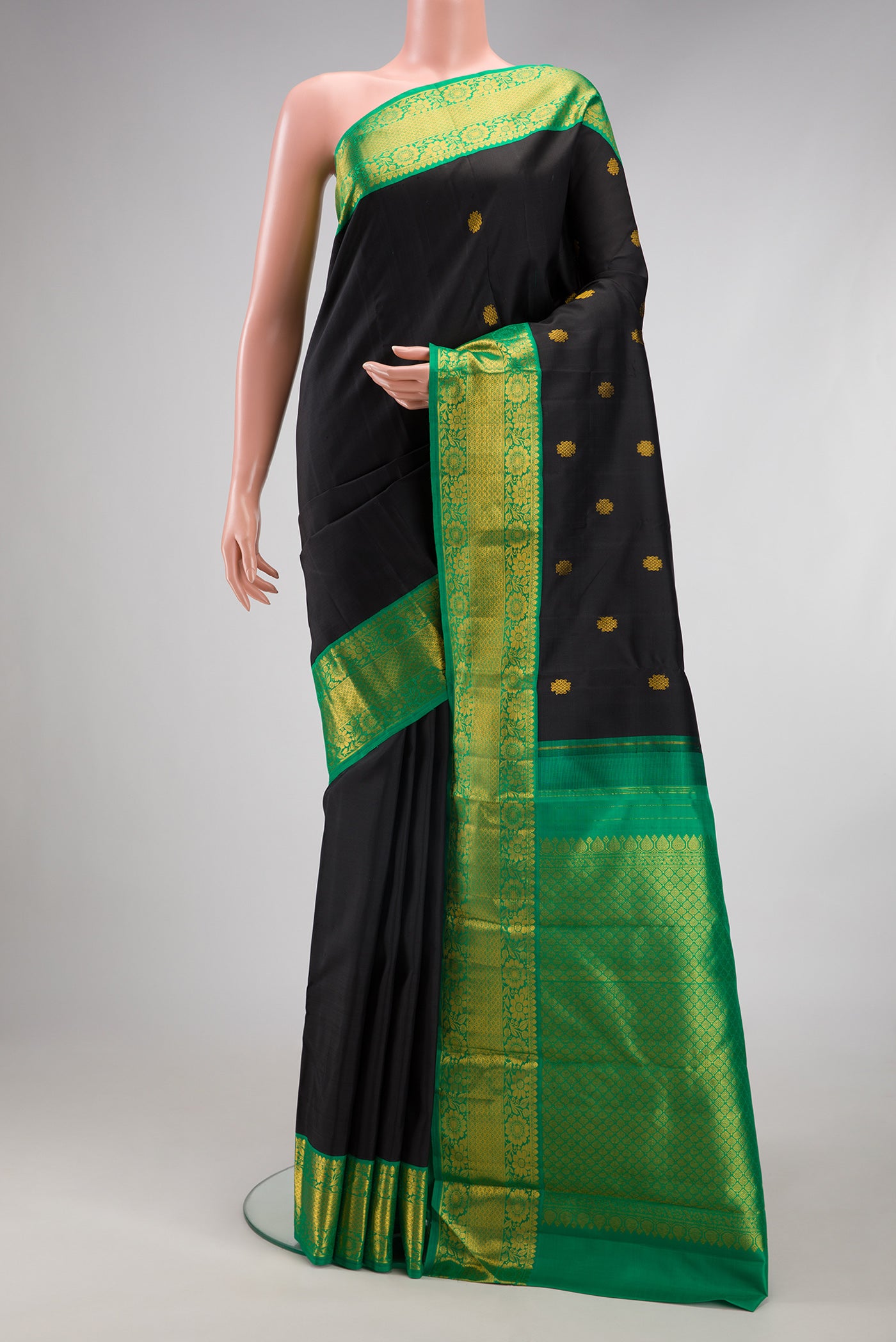 Black Kanjivaram Silk Saree with Zari Butta on the body and Fancy Border.  displayed on a mannequin