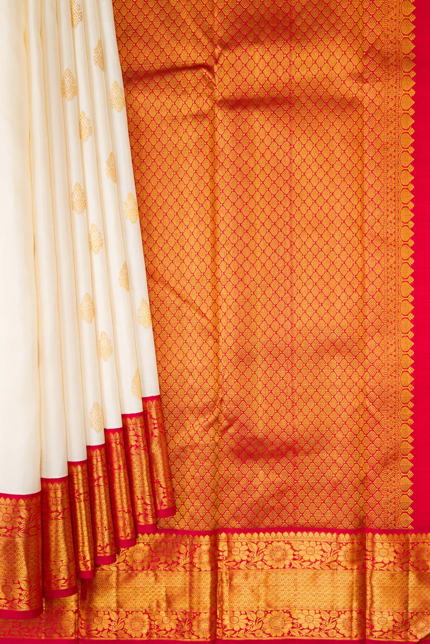 Pleats and pallu of Off White Kanjivaram Silk Saree with Zari Butta on the body and Zari Border. 