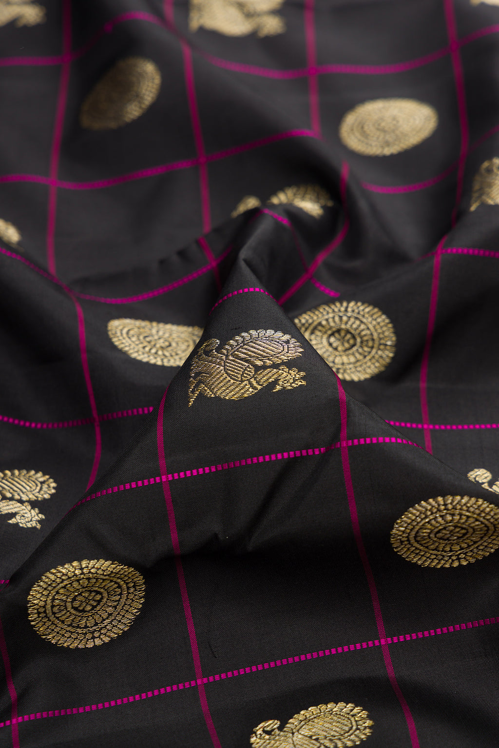 Close up of Pure Silk Black Kanchipuram Saree with Checked design on the body and Without Border.  displaying folds