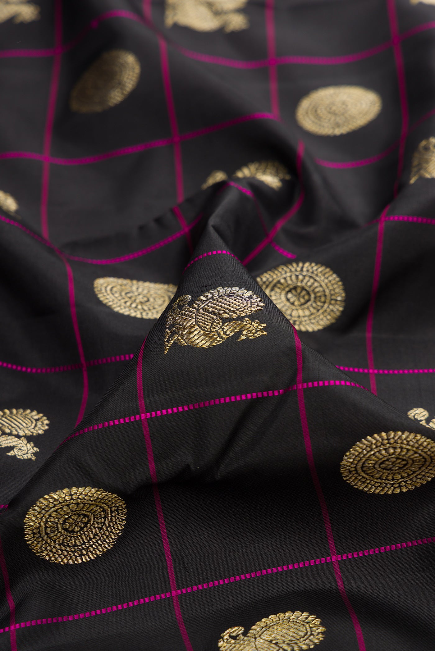 Close up of Pure Silk Black Kanchipuram Saree with Checked design on the body and Without Border.  displaying folds