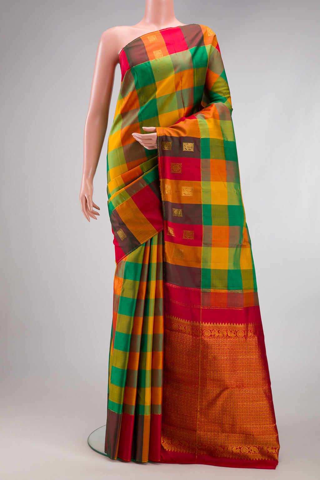 Multi Color Kanchipuram Silk Saree with Checked design on the body and Fancy Border.  displayed on a mannequin