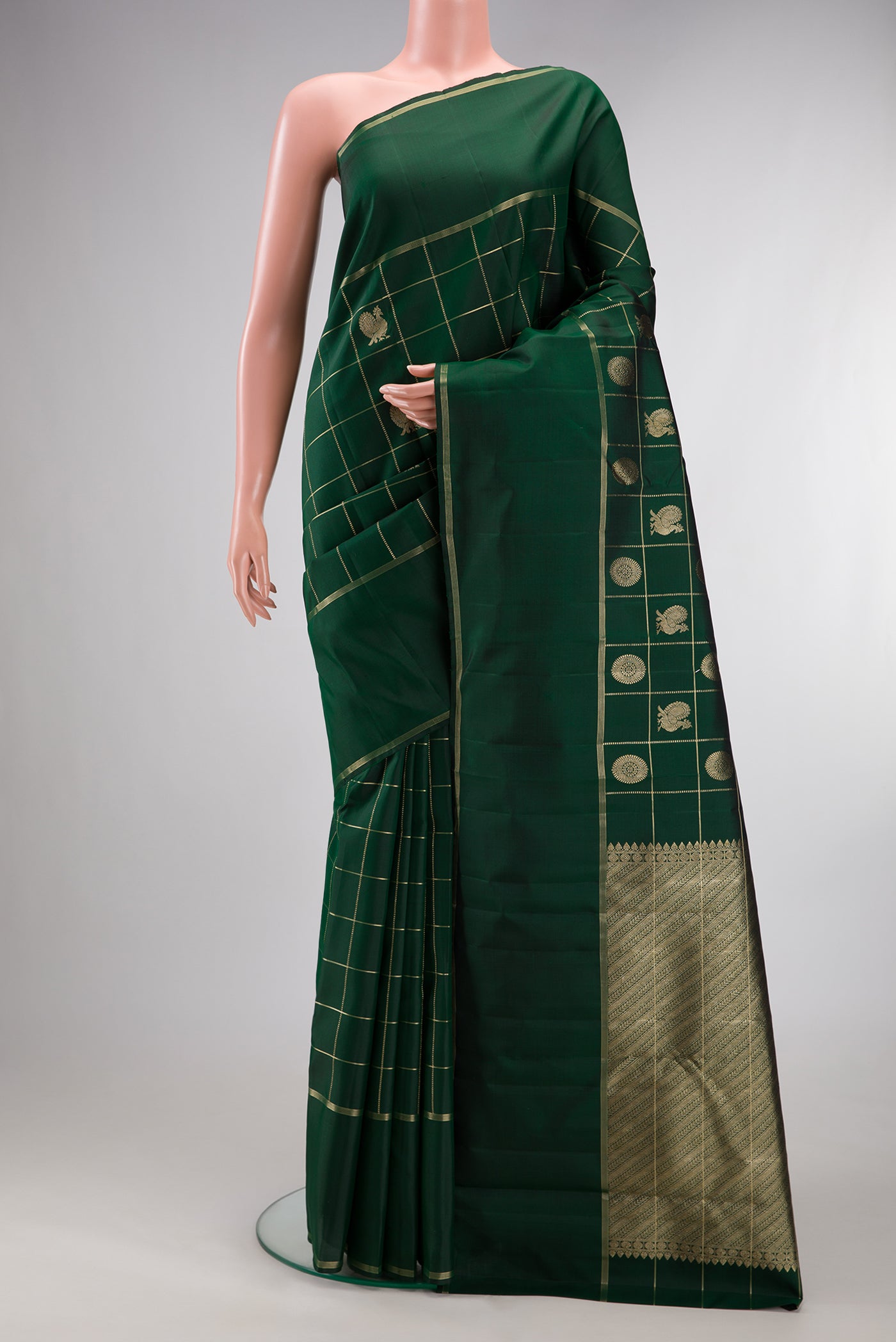 Pure Silk Bottle Green Kanchipuram Saree with Checked design on the body and Plain Border.  displayed on a mannequin