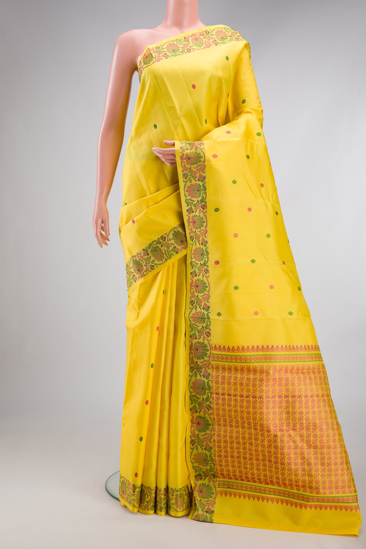 Yellow Kanjivaram Silk Saree with Thread Butta on the body and Thread Border.  displayed on a mannequin