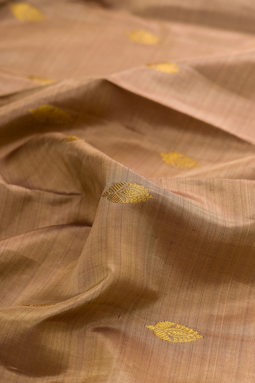 Close up of Pure Silk Brown Kanjivaram Saree with Zari Butta on the body and Zari Border.  displaying folds
