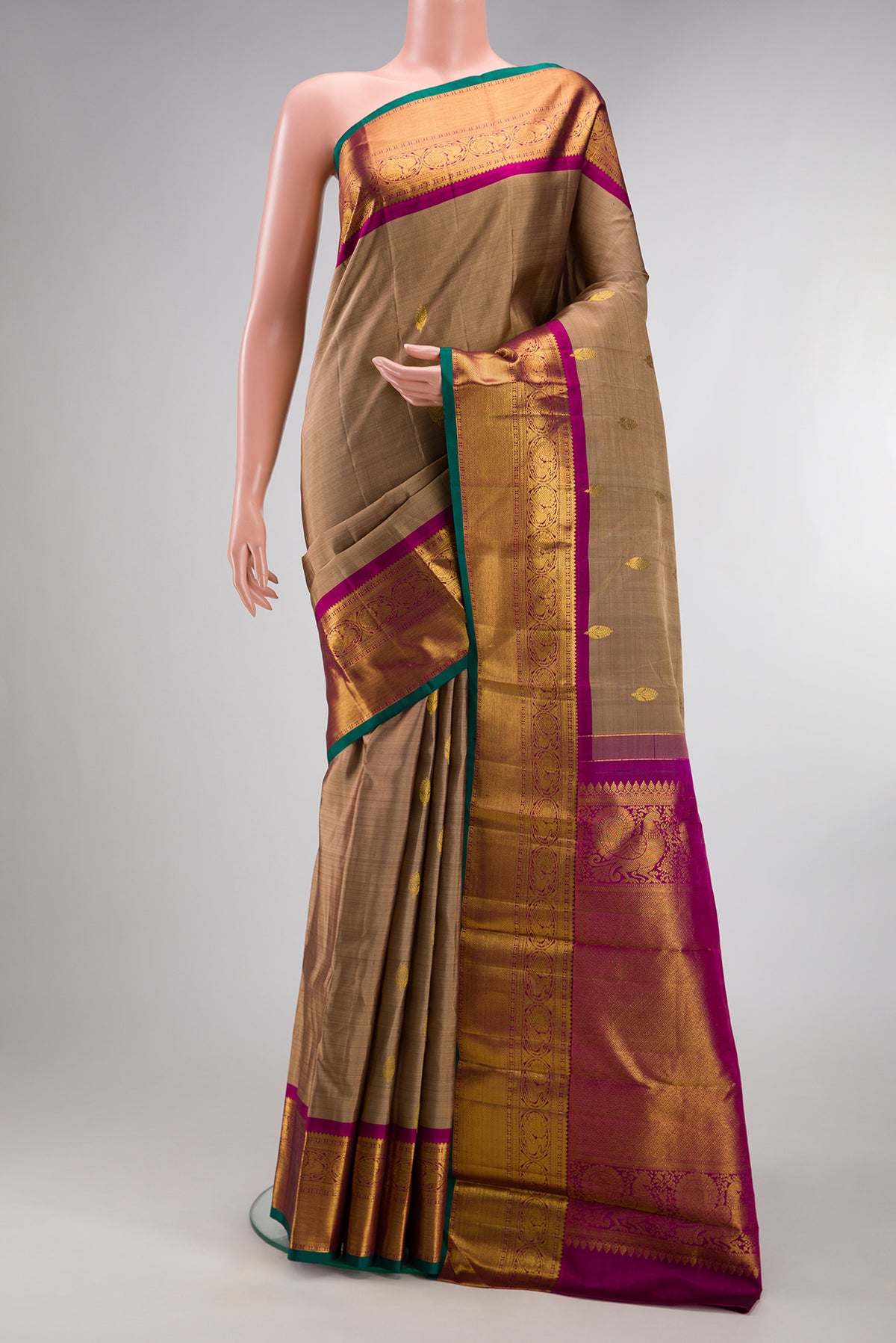 Pure Silk Brown Kanjivaram Saree with Zari Butta on the body and Zari Border.  displayed on a mannequin