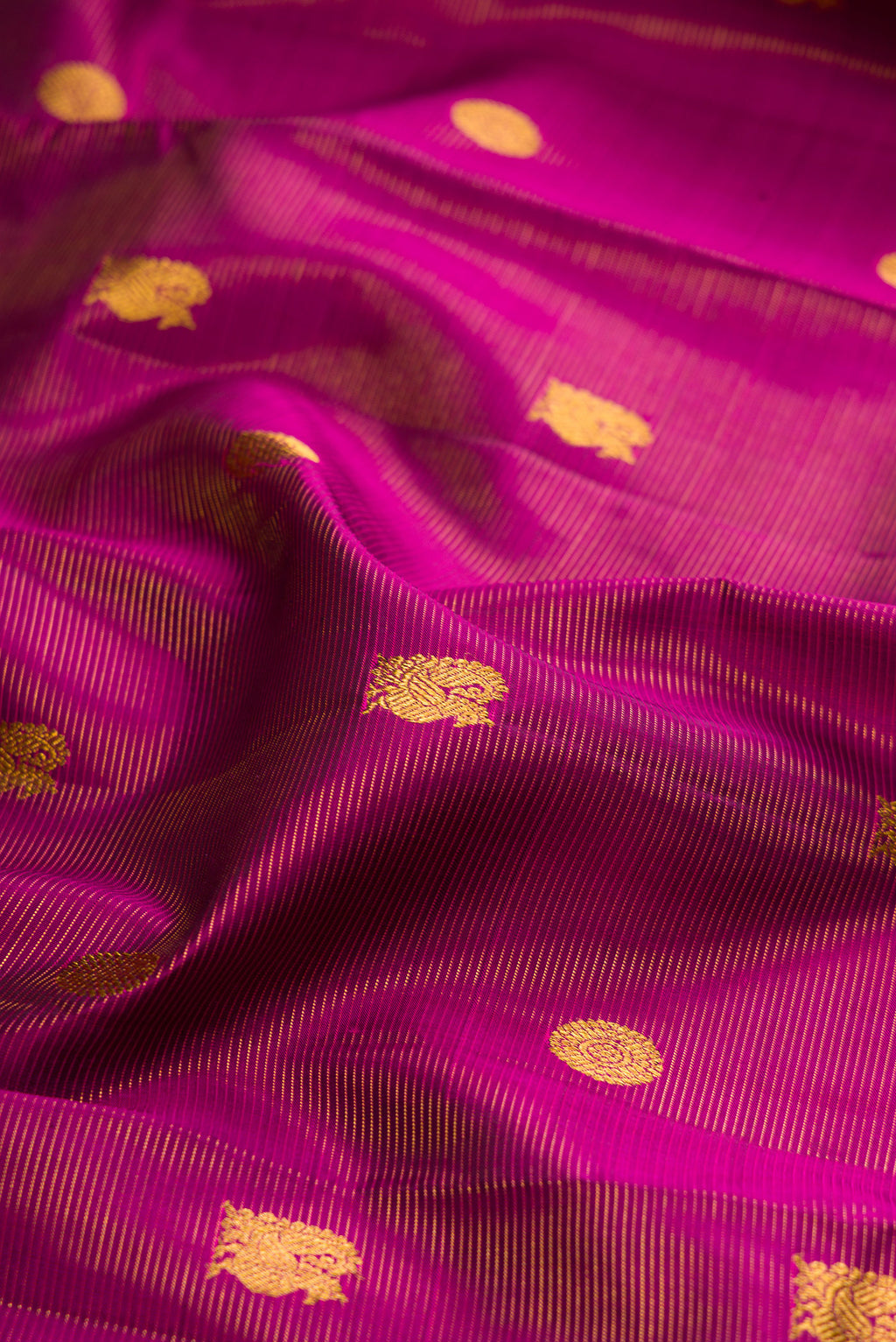 Close up of Purple Kanjivaram Silk Saree with Stripes on the body and Zari Border.  displaying folds