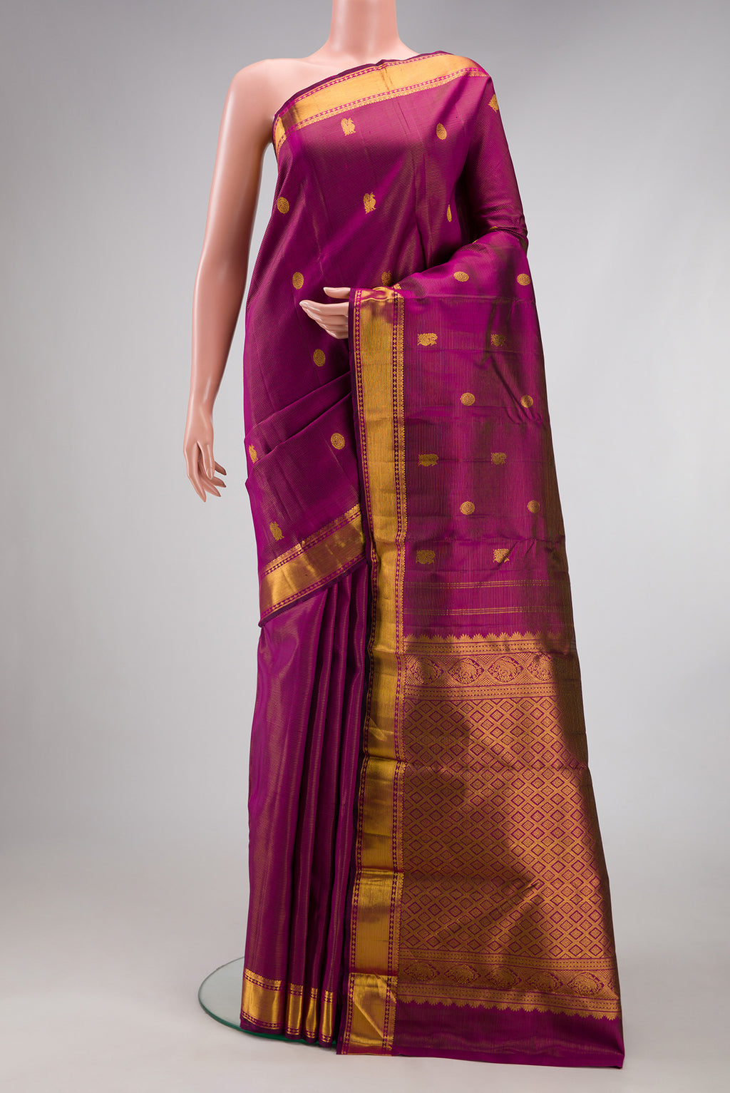 Purple Kanjivaram Silk Saree with Stripes on the body and Zari Border.  displayed on a mannequin
