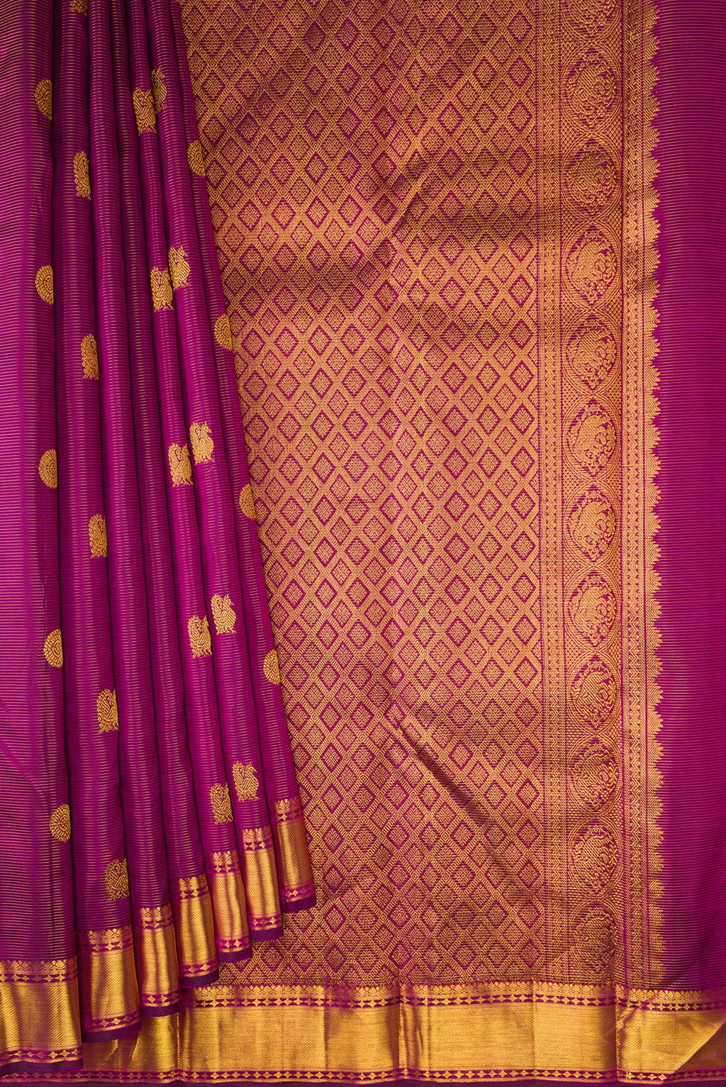 Pleats and pallu of Purple Kanjivaram Silk Saree with Stripes on the body and Zari Border. 