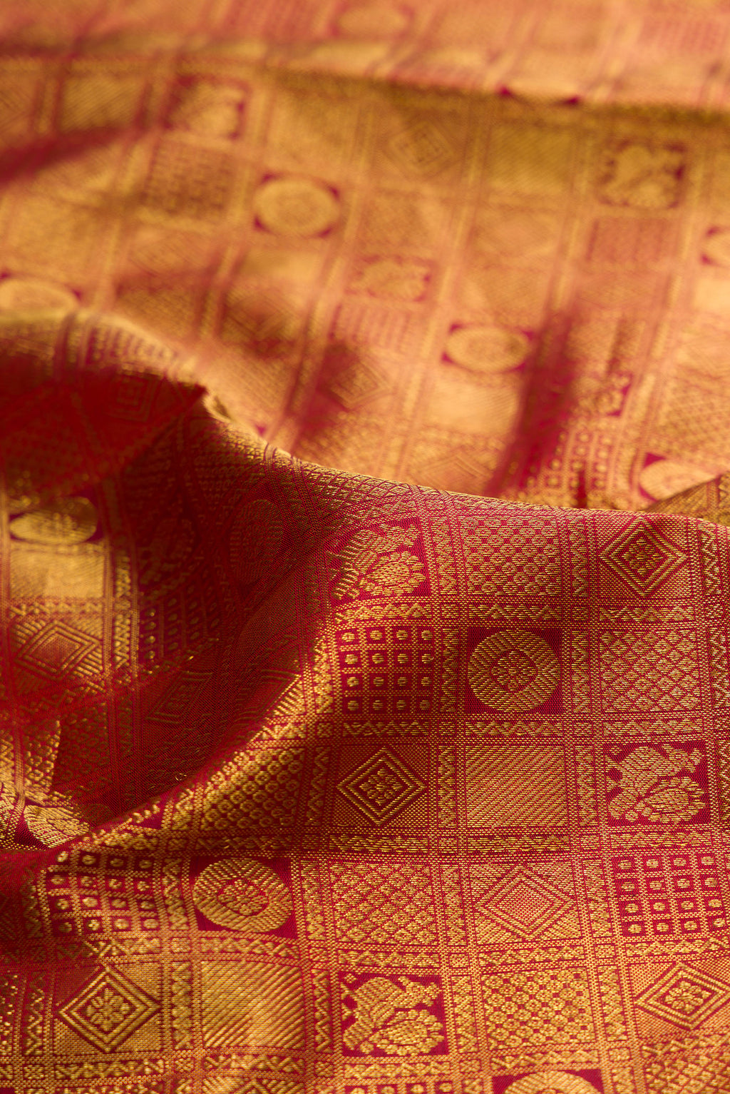 Close up of Maroon Kanjivaram Silk Saree with Zari Brocade on the body and Zari Border.  displaying folds