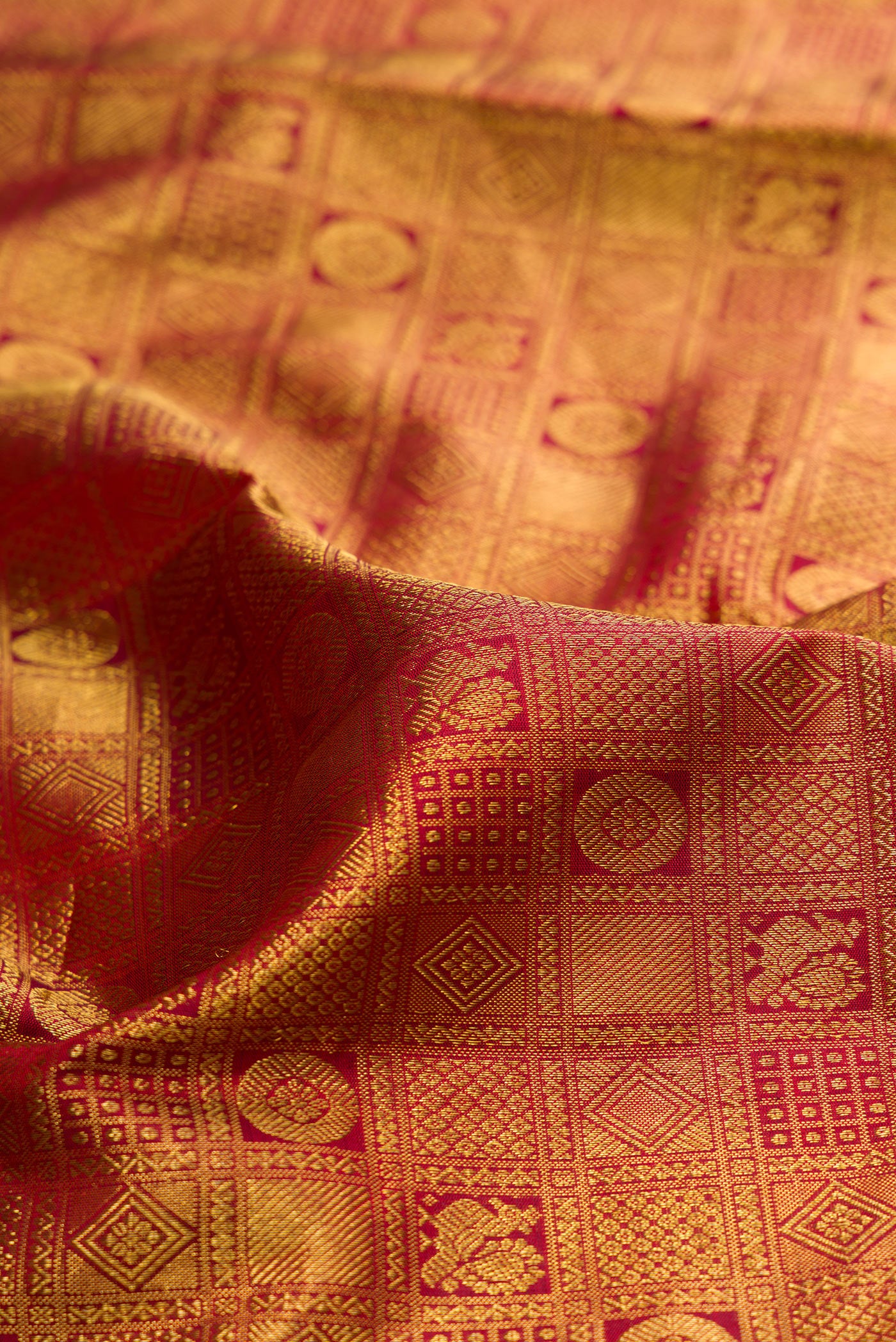 Close up of Maroon Kanjivaram Silk Saree with Zari Brocade on the body and Zari Border.  displaying folds