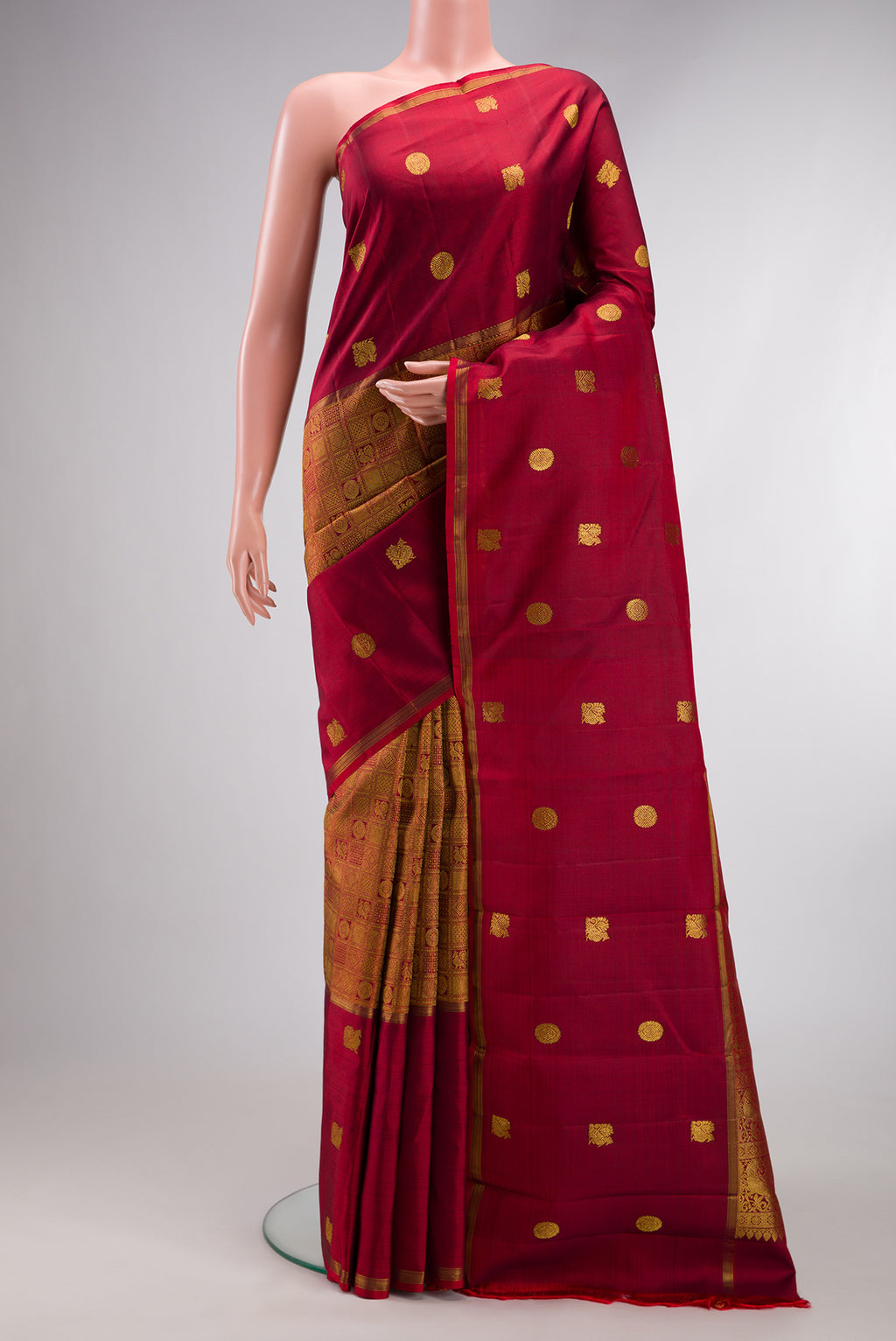 Maroon Kanjivaram Silk Saree with Zari Brocade on the body and Zari Border.  displayed on a mannequin