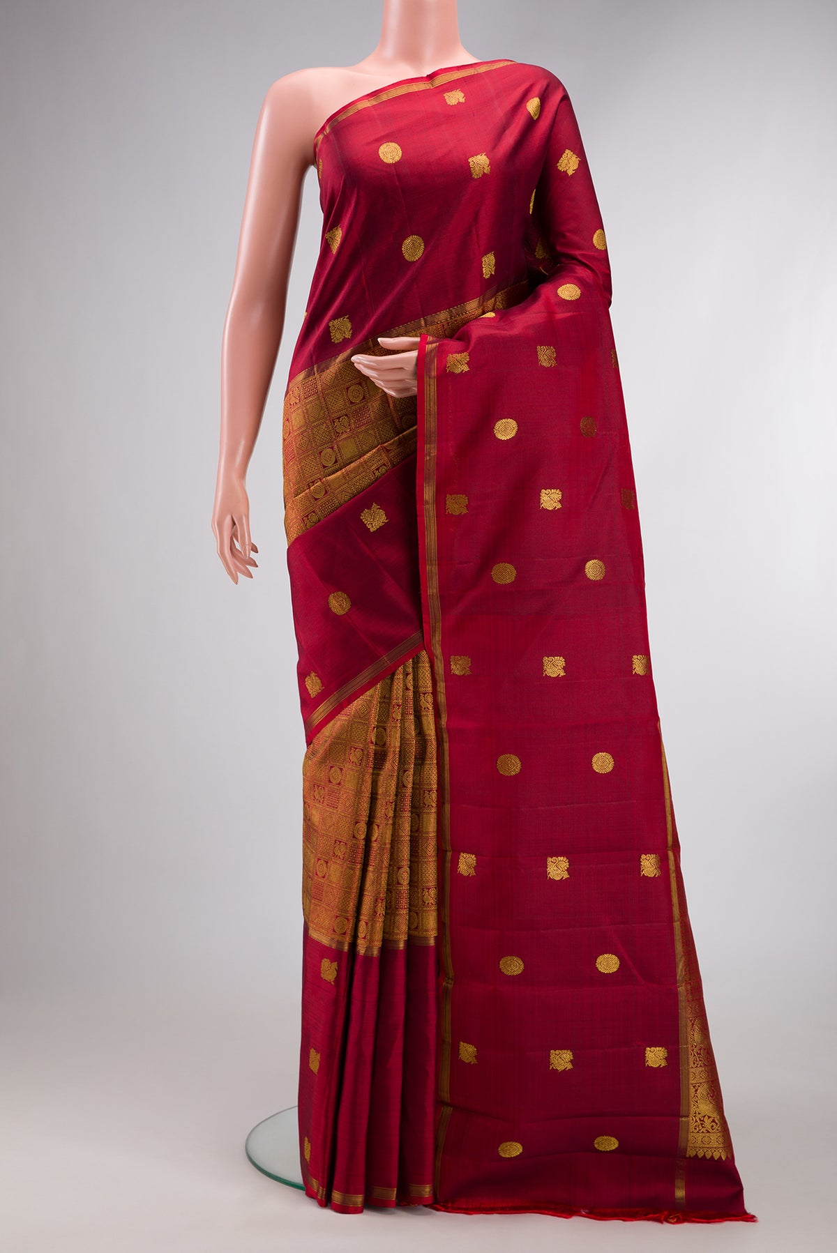 Maroon Kanjivaram Silk Saree with Zari Brocade on the body and Zari Border.  displayed on a mannequin