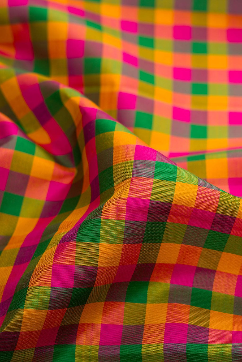 Close up of Multi Color Kanjivaram Silk Saree with Checked design on the body and Zari Border.  displaying folds