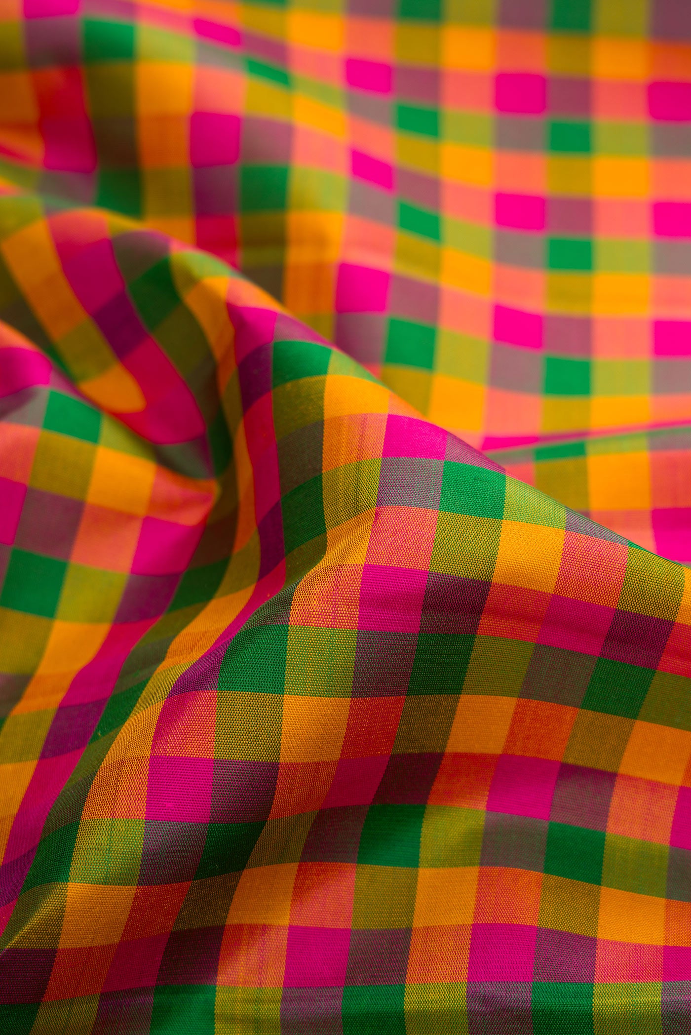 Close up of Multi Color Kanjivaram Silk Saree with Checked design on the body and Zari Border.  displaying folds