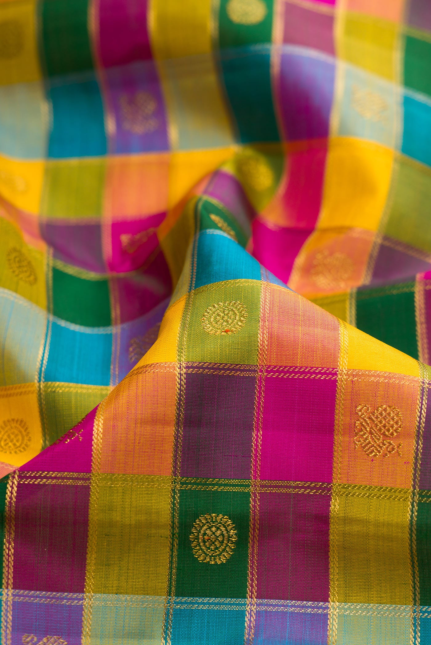 Close up of Multi Color Kanchipuram Silk Saree with Checked design on the body and Zari Border.  displaying folds