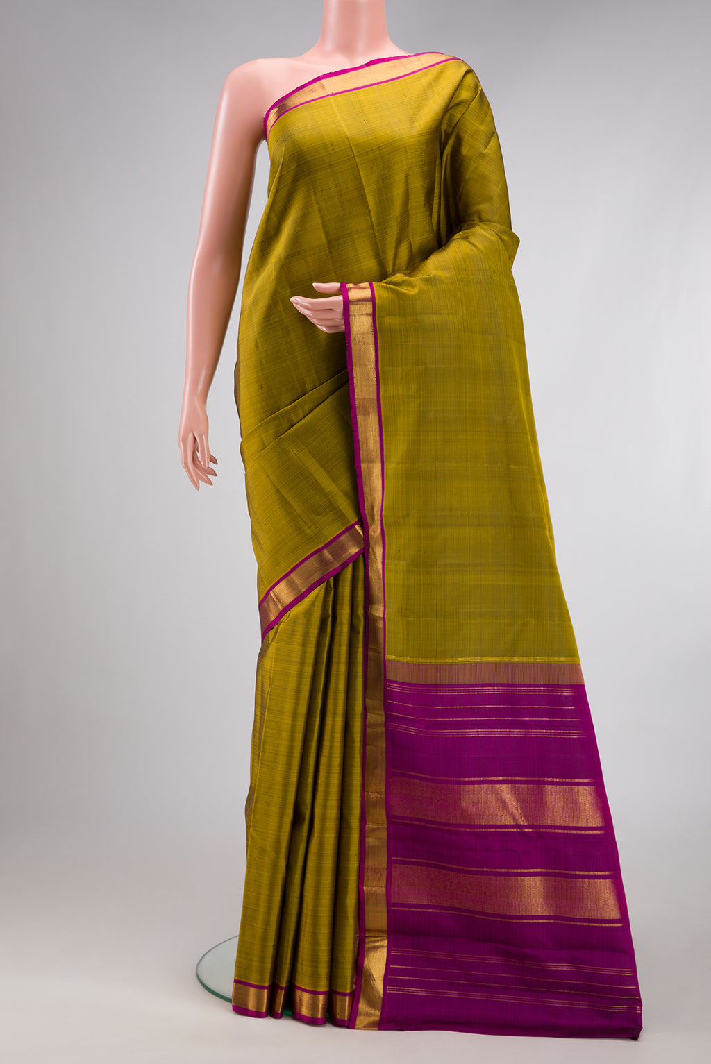 Mehandi Green Kanjivaram Silk Saree with Plain Body and Zari Border.  displayed on a mannequin