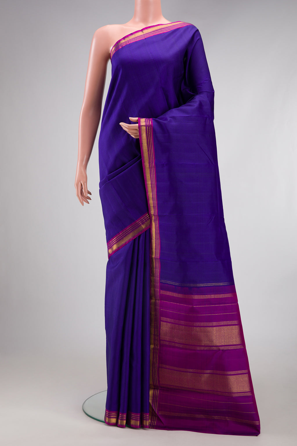Royal Blue Kanjivaram Silk Saree with Plain Body and Zari Border.  displayed on a mannequin