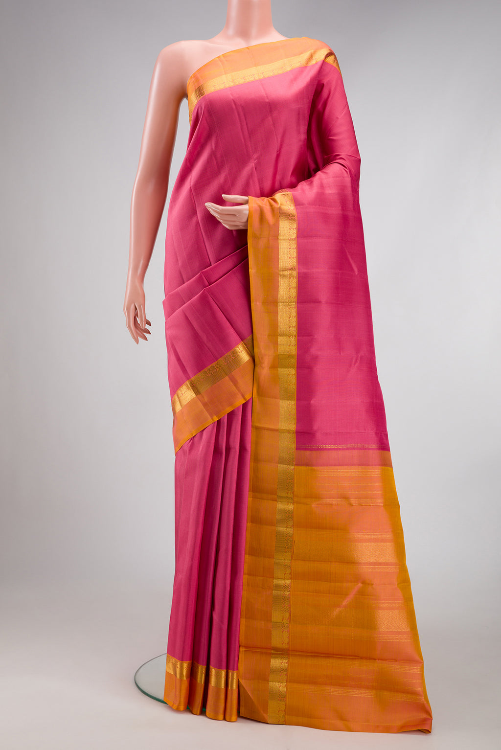 Rose pink Kanjivaram Silk Saree with Plain Body and Zari Border.  displayed on a mannequin