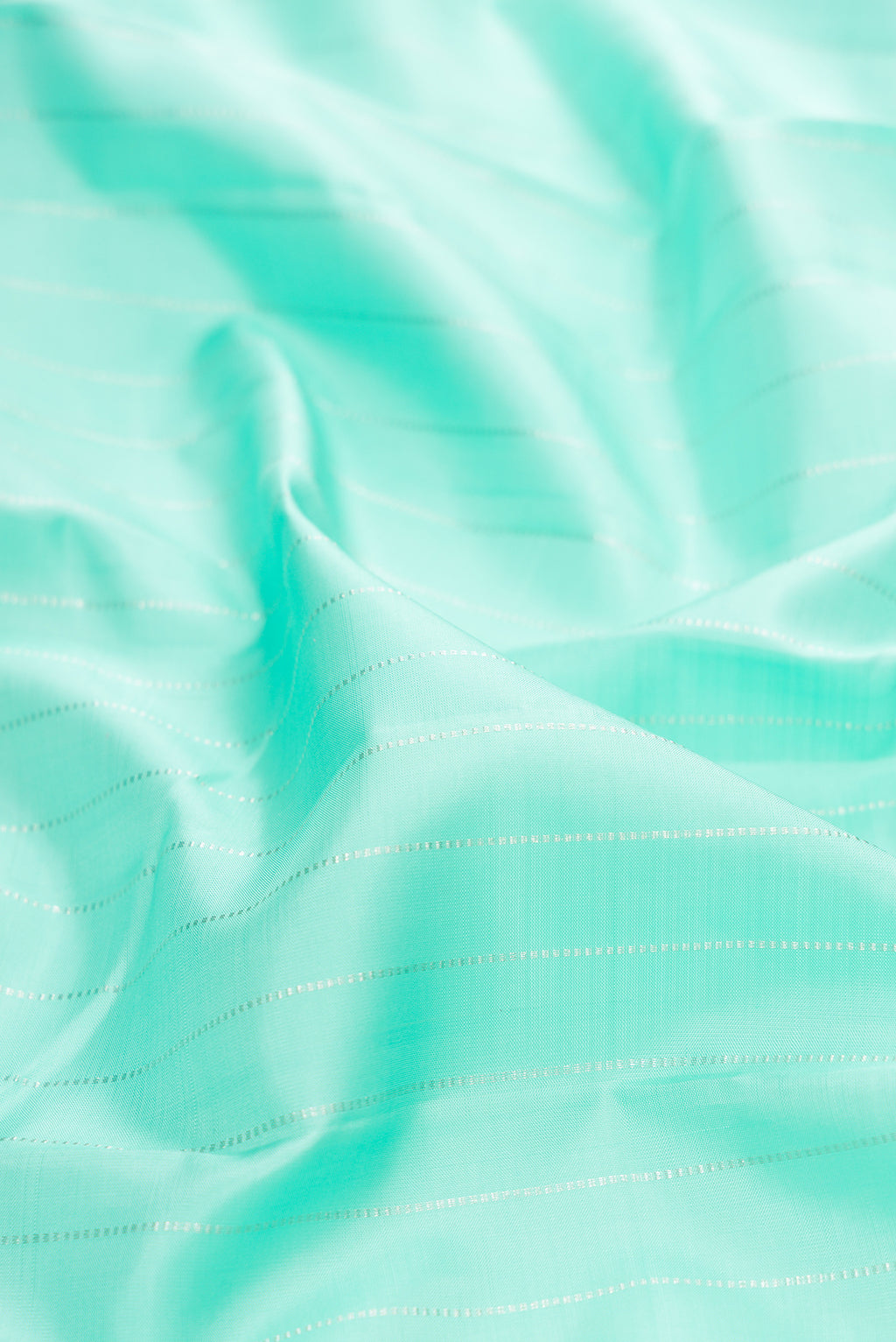 Close up of Sea Green Dual Tone Kanjivaram Silk Saree with Stripes on the body and Without Border.  displaying folds