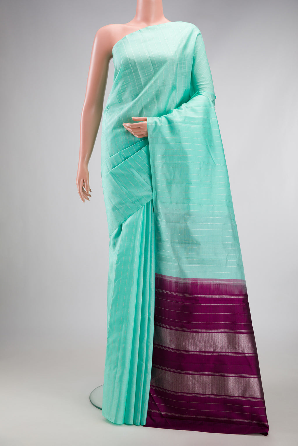 Sea Green Dual Tone Kanjivaram Silk Saree with Stripes on the body and Without Border.  displayed on a mannequin