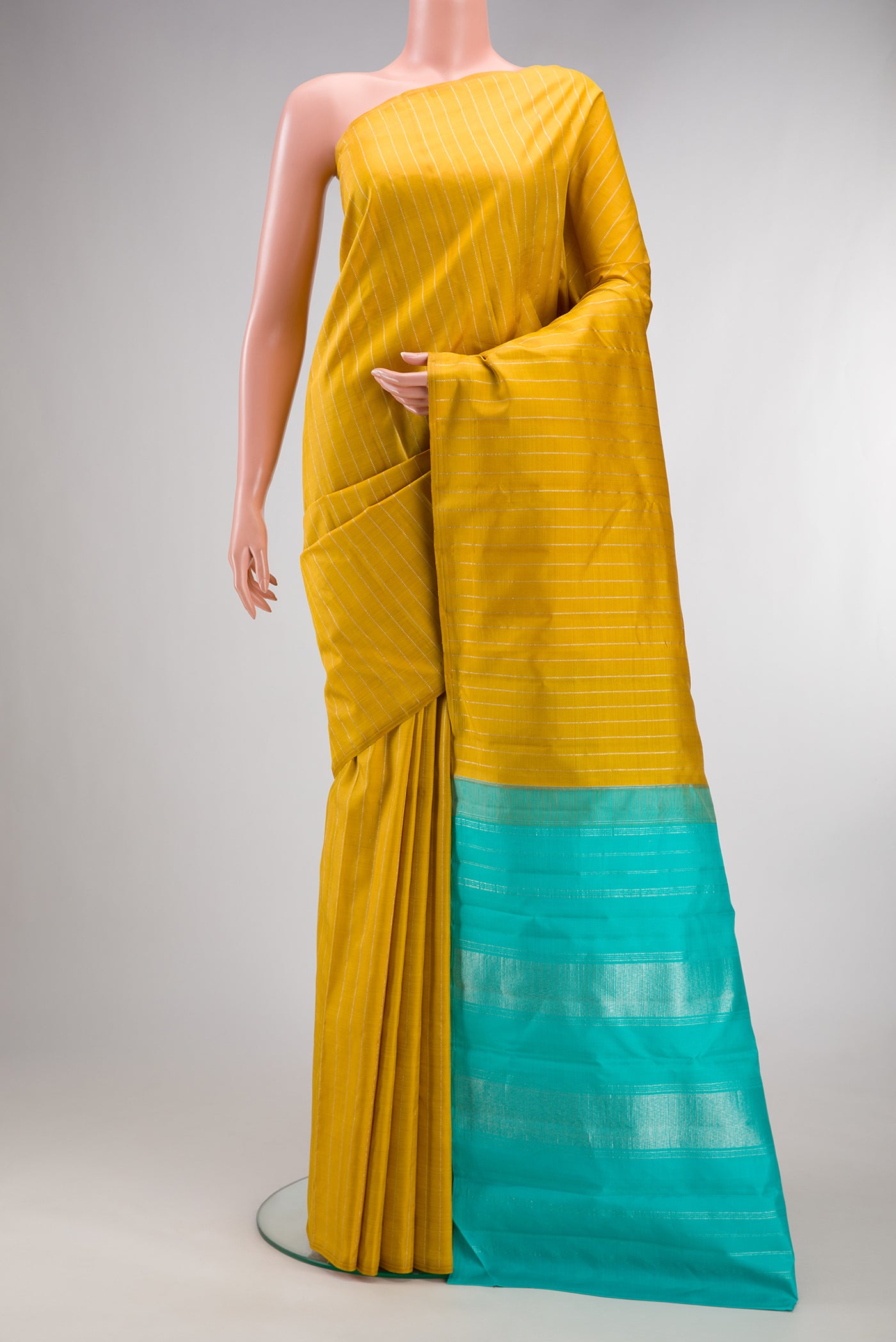 Pure Silk Mustard Kanjivaram Saree with Stripes on the body and Without Border.  displayed on a mannequin
