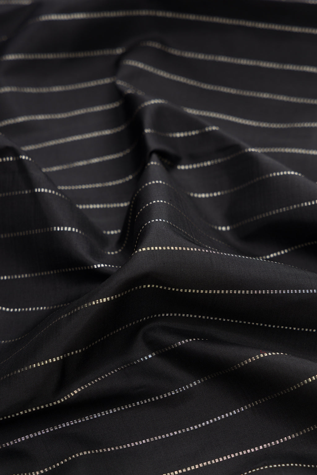 Close up of Pure Silk Black Kanjivaram Saree with Stripes on the body and Without Border.  displaying folds