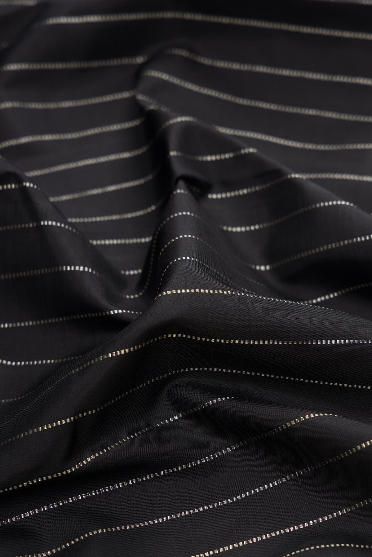 Close up of Pure Silk Black Kanjivaram Saree with Stripes on the body and Without Border.  displaying folds