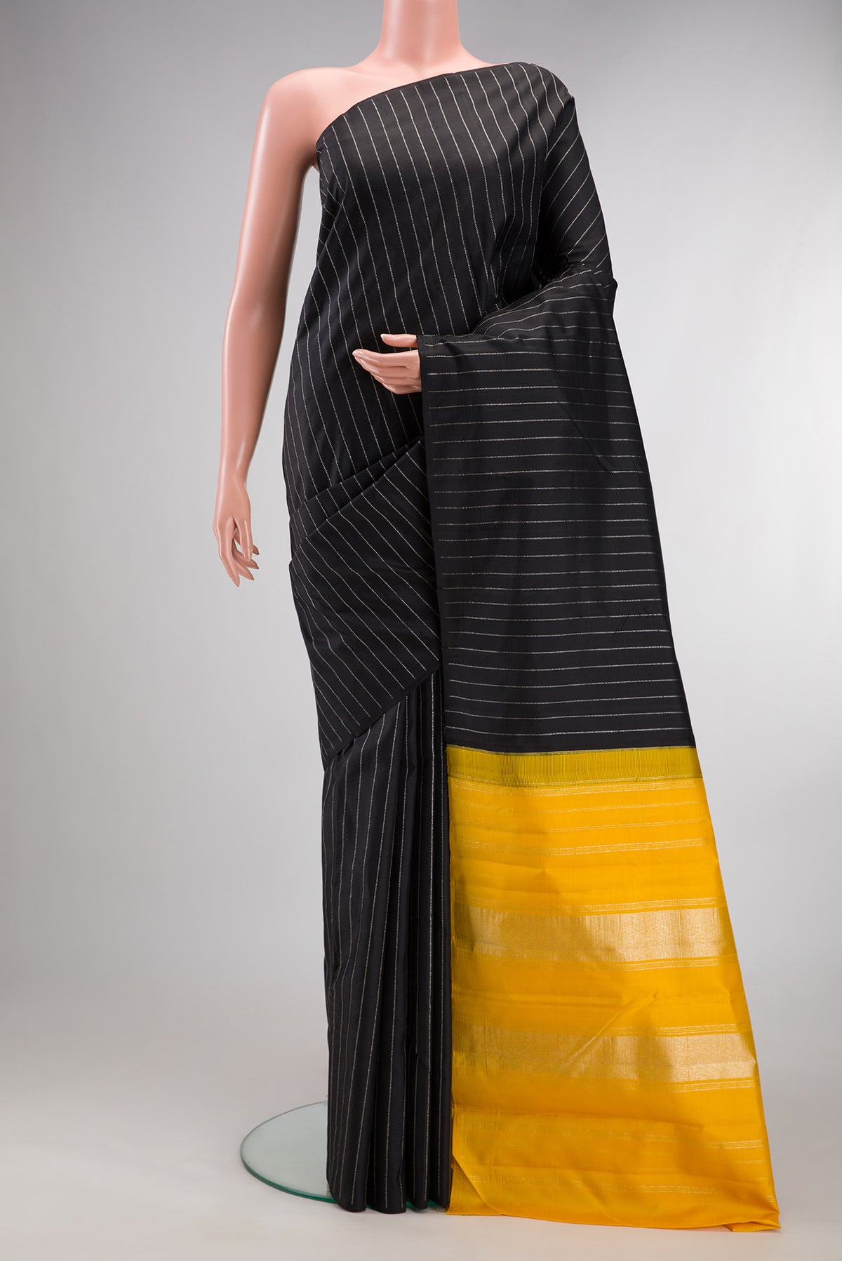 Pure Silk Black Kanjivaram Saree with Stripes on the body and Without Border.  displayed on a mannequin