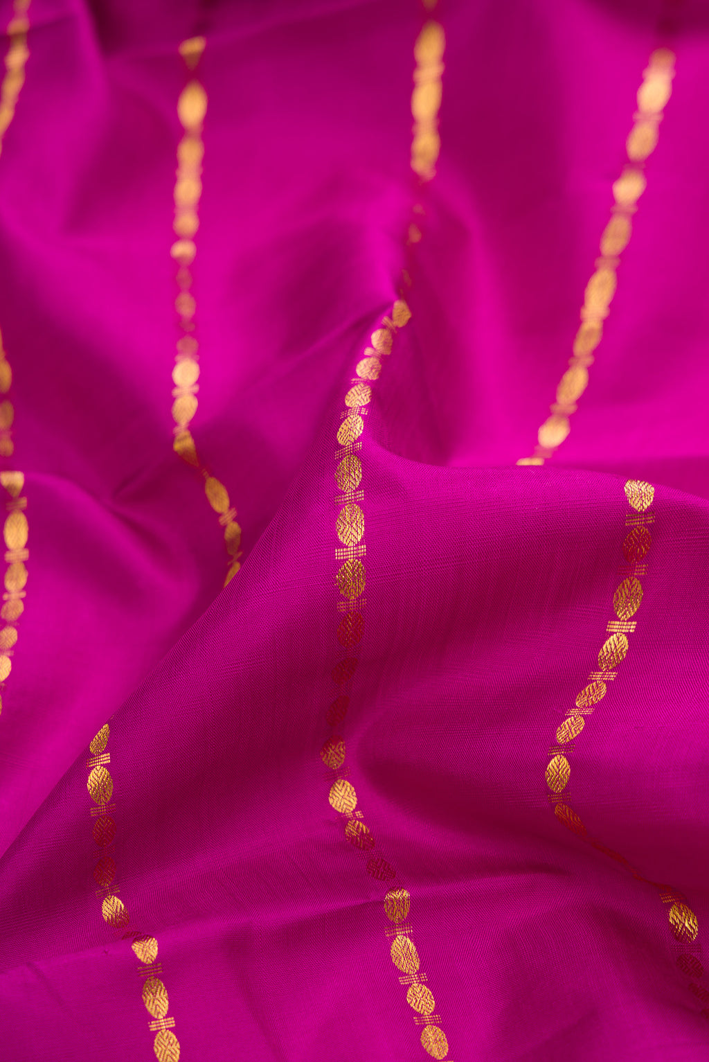 Close up of Pure Silk Magenta Kanchipuram Saree with Stripes on the body and Without Border.  displaying folds