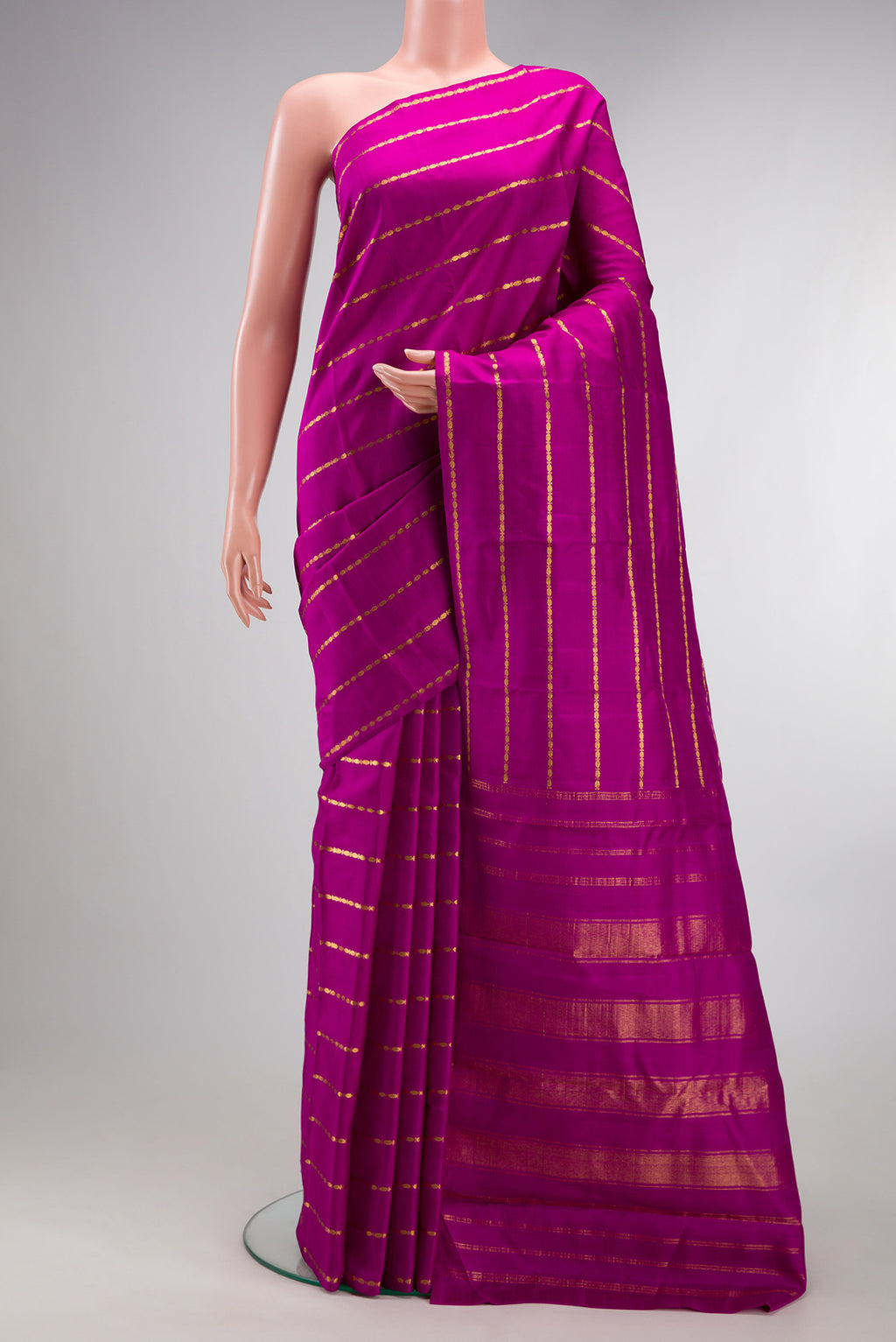 Pure Silk Magenta Kanchipuram Saree with Stripes on the body and Without Border.  displayed on a mannequin