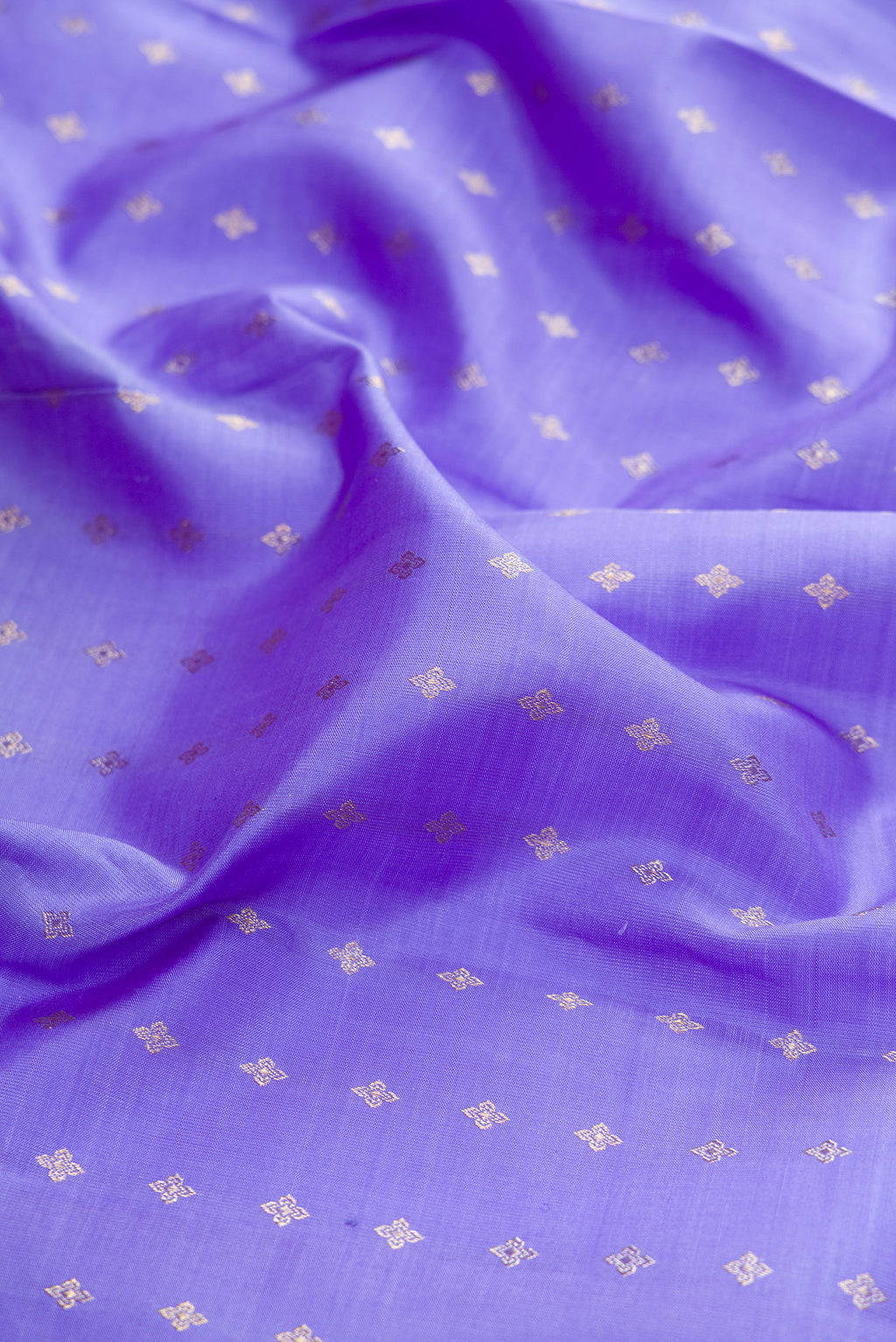 Close up of Lavender Kanchipuram Silk Saree with Zari Butta on the body and Without Border.  displaying folds